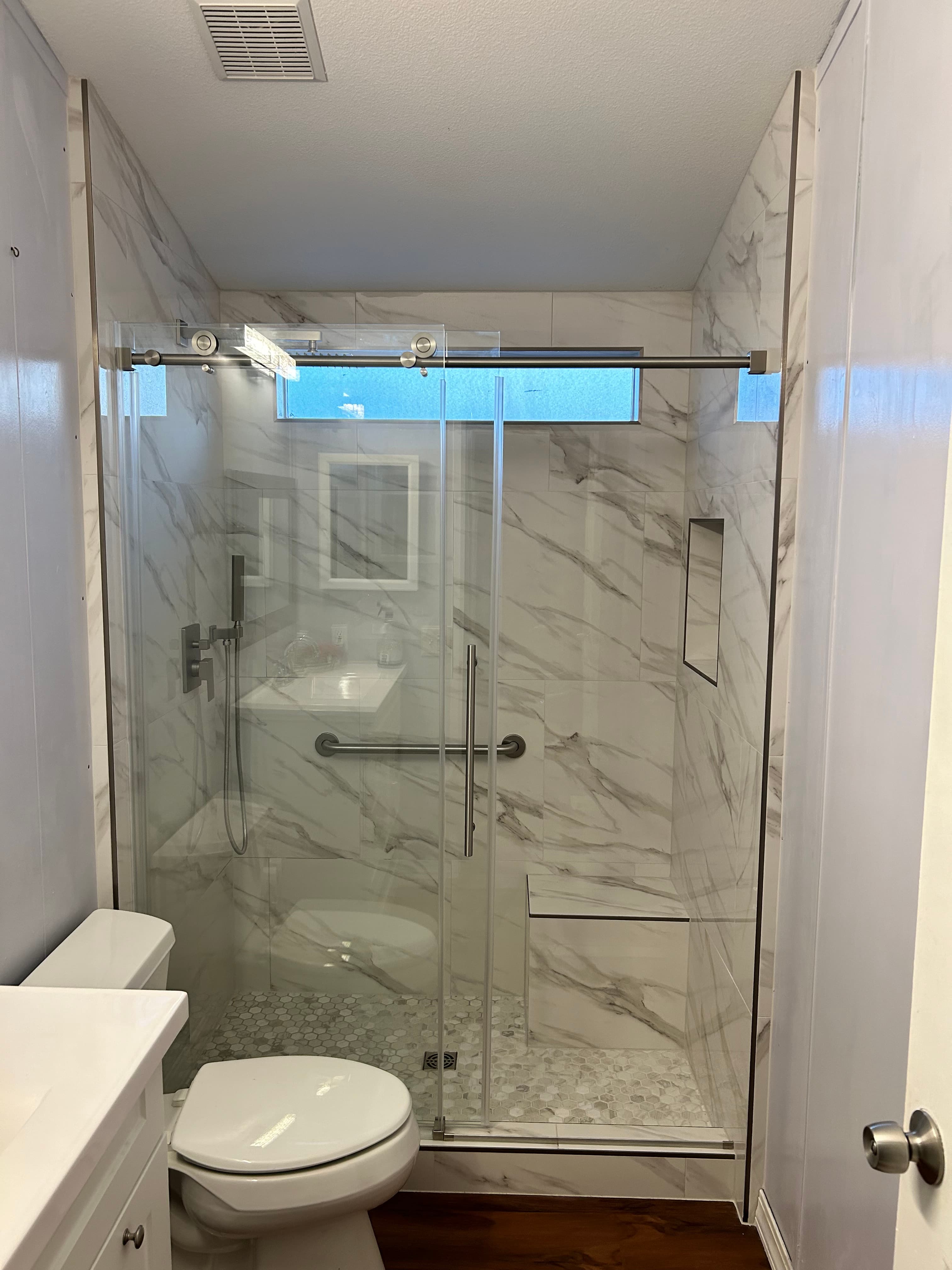 Marble tile shower with glass door remodel Clark County WA